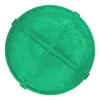 A green, circular manhole cover with a cross-shaped reinforcement pattern on top. Produktbild-Vorschau