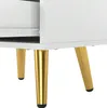 A close-up view of the bottom section of a white nightstand, showing its golden metal legs. Produktbild-Vorschau