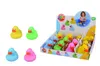 A display box of colorful rubber ducks with a child in the background. Anteprima dell’immagine prodotto