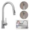 A kitchen faucet with a pull-down sprayer is shown in a collage of images. One image shows the faucet in use, with a hand holding the sprayer over a pitcher. Other images show close-ups of the sprayer head and the faucet's pull-down mechanism. Produktbild-Vorschau
