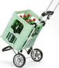 A shopping trolley filled with bottles of drink. Produktbild-Vorschau