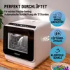 A white countertop dishwasher is shown on a wooden surface, with marketing text and icons highlighting its features. Produktbild-Vorschau