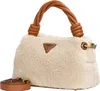 A beige fuzzy handbag with brown leather handles and strap, against a white background. Produktbild-Vorschau
