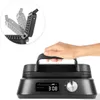 A hand is shown holding the handle of a black waffle maker. Náhľad obrázku produktu