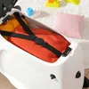 A child's suitcase filled with clothes, with toys and a pillow in the background. Produktbild-Vorschau