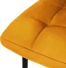 A close-up view of a mustard yellow velvet chair seat with diamond tufting. Náhled obrázku produktu