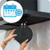 Hands holding a charcoal filter under a kitchen range hood, with an icon indicating filter replacement timing. Produktbild-Vorschau