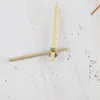 A close-up view of clock hands on a textured surface. Voir les images du produit