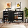Two black shoe cabinets are shown in a room with artwork on the wall and a plant. Produktbild-Vorschau