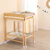 A baby changing table with a bathtub and accessories in a room. Produktbild-Vorschau