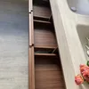 An open cabinet with shelves next to a sink. Anteprima dell’immagine prodotto