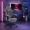 A gaming chair is set up in a dimly lit room with neon lighting. Produktbild-Vorschau