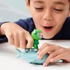 A child playing with a Paw Patrol Rocky figure on a toy shark. Anteprima dell’immagine prodotto