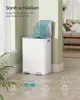 A white trash can with two compartments is shown in a room with a woman relaxing on a couch in the background. Text overlays describe the quiet operation of the trash can. Produktbild-Vorschau