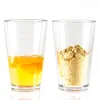 Two glasses, one with egg yolk and white, the other with powder. Produktbild-Vorschau
