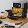 An air fryer oven is shown on a kitchen counter, with food inside and on a tray. Produktbild-Vorschau