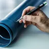 A hand is using a marker to draw on a blue pipe. Anteprima dell’immagine prodotto