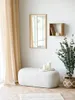 A minimalist interior scene featuring a bench, mirror, shelf, plant, and curtains. Voir les images du produit