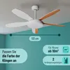 A ceiling fan with white and wood-colored blades is shown mounted on a white ceiling against a light blue wall. Produktbild-Vorschau