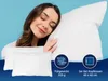 A woman is sleeping peacefully on a pillow, with two pillows shown in the foreground. There are icons and text indicating product features. Produktbild-Vorschau