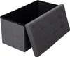 A gray fabric storage ottoman with its lid open, showing the black interior. Produktbild-Vorschau