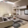 A modern living room with a sectional sofa, coffee table, and entertainment unit. Anteprima dell’immagine prodotto