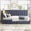 A dark gray velvet daybed with a tufted headboard and footboard, set up in a room with large windows and a rug. Náhled obrázku produktu