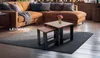 A living room scene featuring a sectional sofa, nesting coffee tables, and a rug. Náhled obrázku produktu