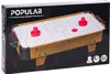 The image shows the packaging of a wooden air hockey game. The packaging is black with the product name and an image of the air hockey table on the front. Anteprima dell’immagine prodotto