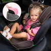 A young girl is sitting in a car seat inside a car. Produktbild-Vorschau
