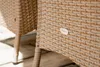A close-up shot of the woven texture of outdoor furniture, showing a small brand logo. Náhled obrázku produktu