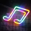 A neon sign shaped like a musical note, lit with a rainbow of colors, is displayed on a grid-patterned surface. Produktbild-Vorschau
