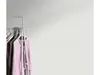 A clothing rack with several garments hanging on it, against a plain background. Produktbild-Vorschau