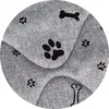 A close-up view of a gray fabric with black paw print and bone patterns. Voir les images du produit