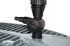 A close-up view of a black plastic valve and hose fitting attached to a gray grate-like surface. Produktbild-Vorschau