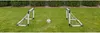 Two small soccer goals and a soccer ball are set up on a green lawn with a hedge in the background. Voir les images du produit