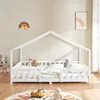 A child's bed with a house frame, decorated with stuffed animals and a rug with toys. Náhled obrázku produktu
