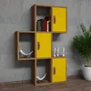 A modular shelving unit with yellow doors and walnut-colored frames, displayed against a textured gray wall. Produktbild-Vorschau