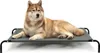 A dog is lying on a raised pet bed against a white background. Anteprima dell’immagine prodotto