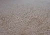A close-up, angled view of a textured carpet. Voir les images du produit