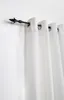 A close-up view of a black curtain rod with a decorative finial and white curtains hanging from it. Produktbild-Vorschau