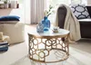 A living room scene with a coffee table, sofa, and decorative items. Produktbild-Vorschau