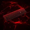 A black keyboard is shown on a dark background with red abstract lines resembling cracks or energy. Produktbild-Vorschau