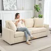 A woman sits on a cream-colored sofa, holding a mug. Podgląd zdjęcia produktu