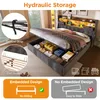 A bed with its storage compartment open, showing organized items inside, and diagrams illustrating features. Produktbild-Vorschau