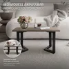 A coffee table with black metal legs and a wooden top, placed on a rug in a living room setting. Náhľad obrázku produktu