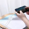 A person is using a smartphone with an adapter connected to it, playing a game. Náhľad obrázku produktu