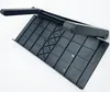 A black plastic monitor stand with a grid pattern on its surface and a handle. Produktbild-Vorschau