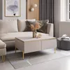 A modern living room scene with a couch, coffee table, and decorative items. Produktbild-Vorschau