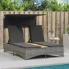 A double sun lounger with a canopy and cushions is placed on a patio next to a swimming pool, with a wooden fence and trees in the background. Produktbild-Vorschau
